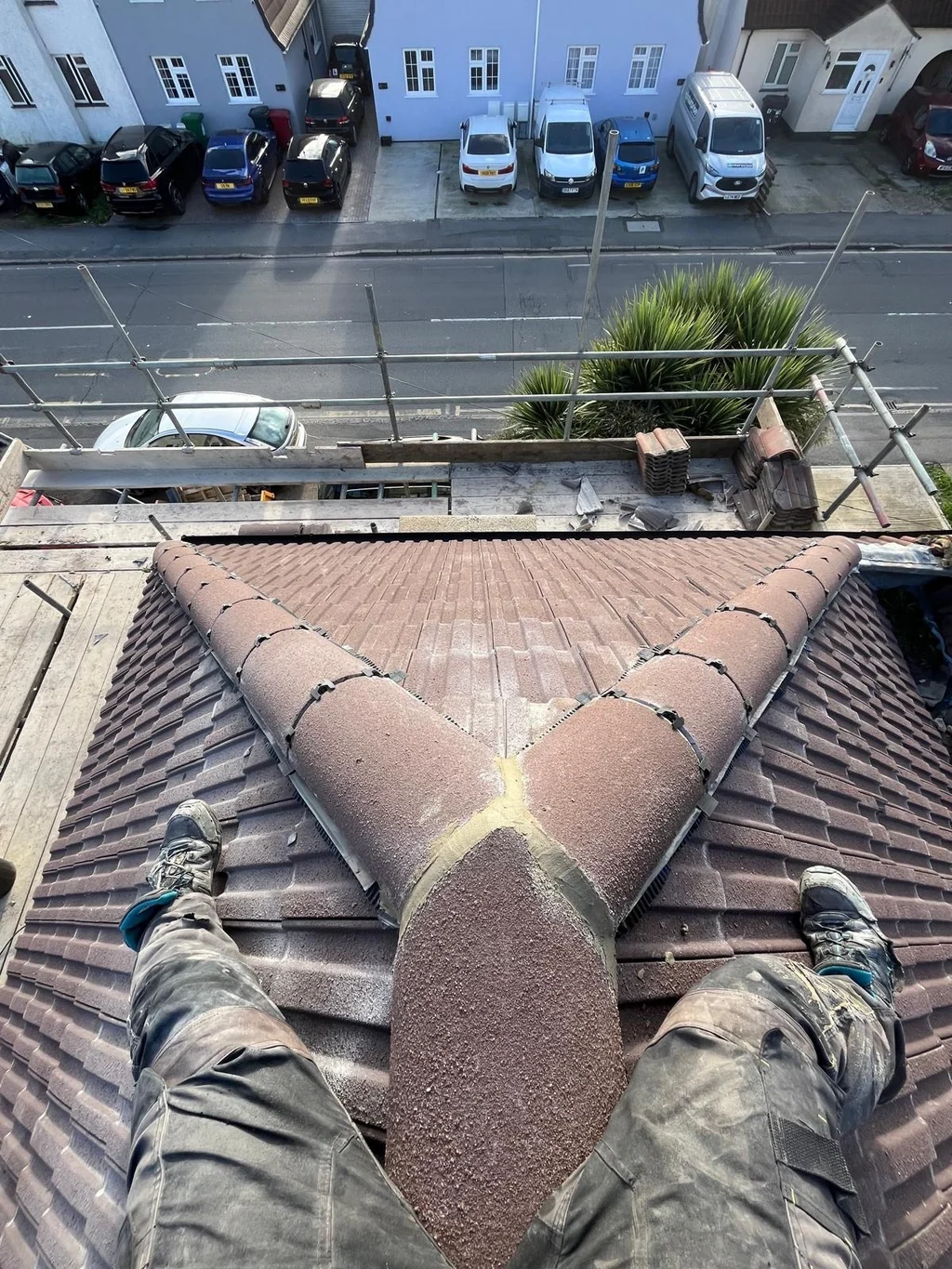 Brown tiled hip junction with the photographer's legs in view